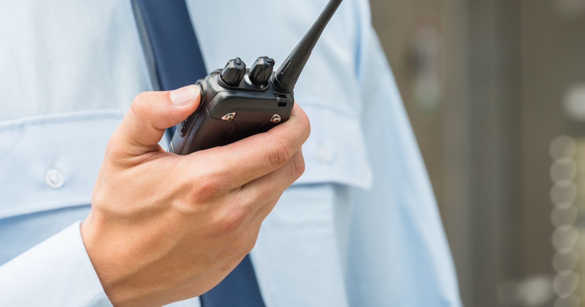 guard holding handheld transceiver