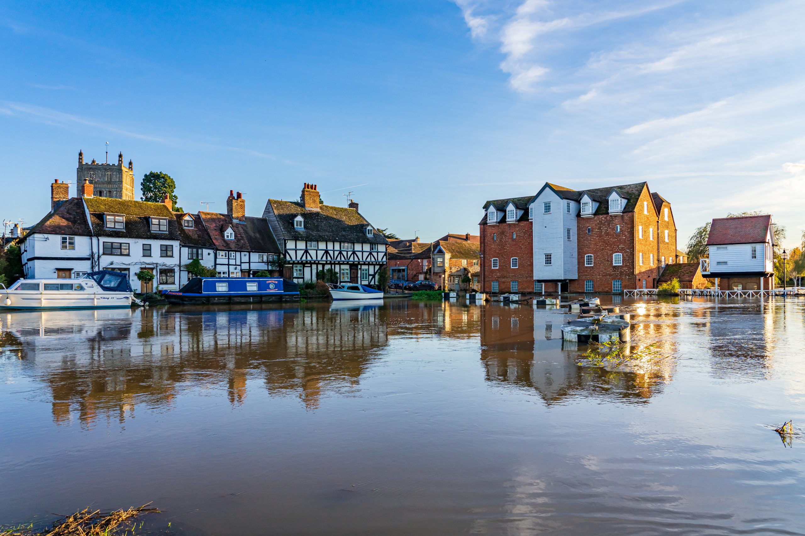 The Abbey Mill, Tewkesbury reflected in flood water from River Avon, with Tewkesbury Abbey in background